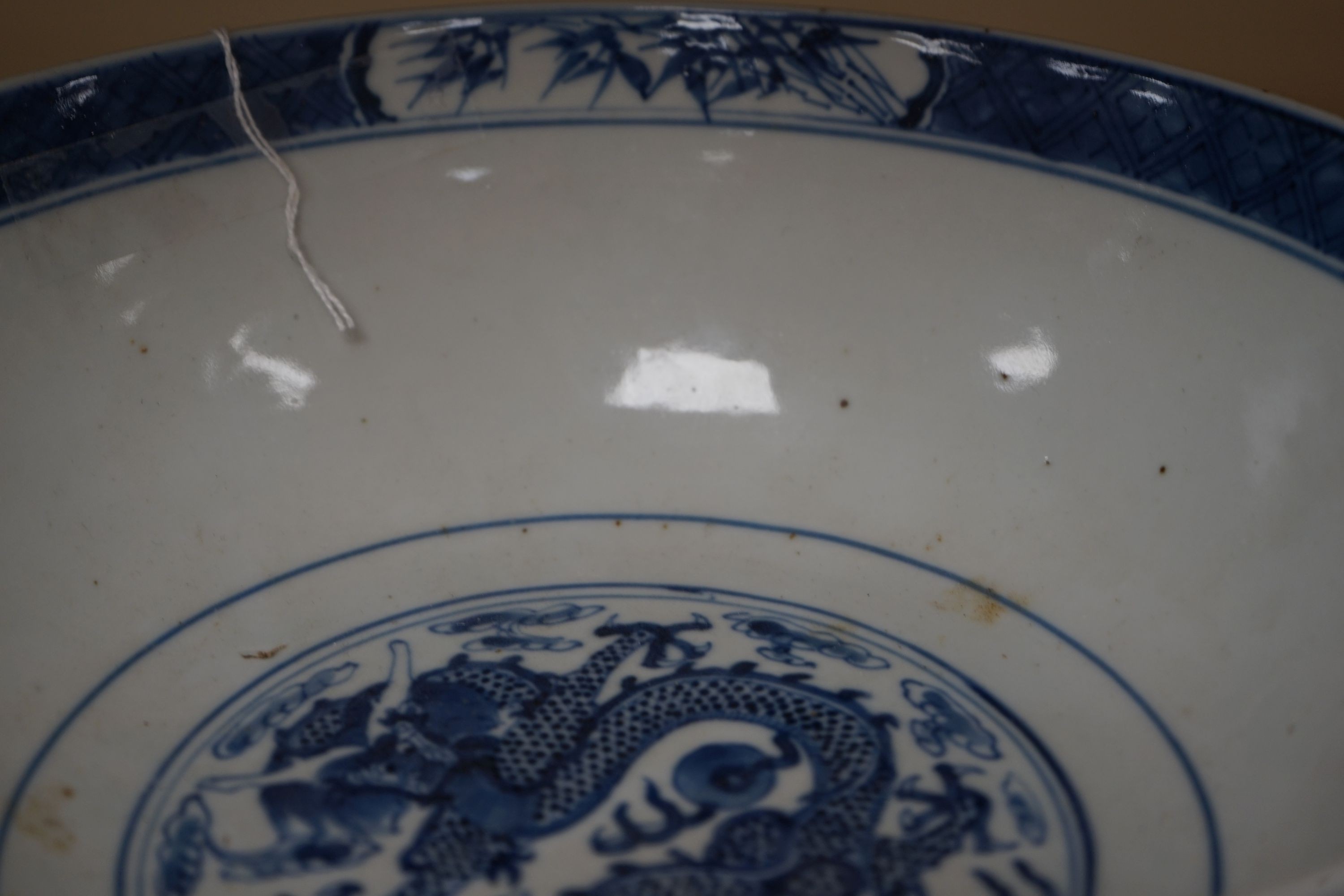 A Chinese blue and white ‘dragon’ bowl, Kangxi mark, late 19th century 25cm